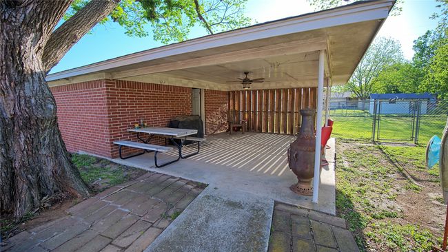 View of patio with a gate, a ceiling fan, and fence | Image 11