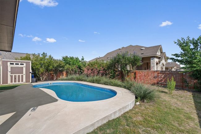 View of pool with a patio and a fenced backyard | Image 25