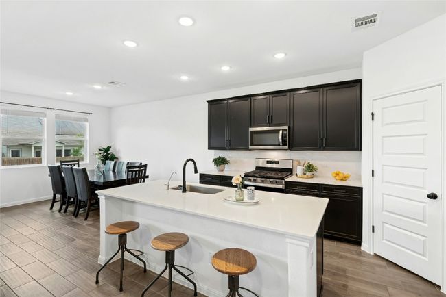 Kitchen with Center, island, quartz countertops and gas cooking | Image 5