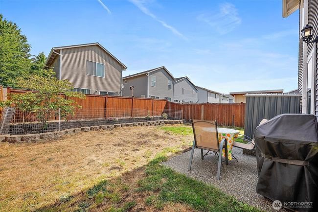 Fully fenced back yard with patio and raised garden. | Image 29