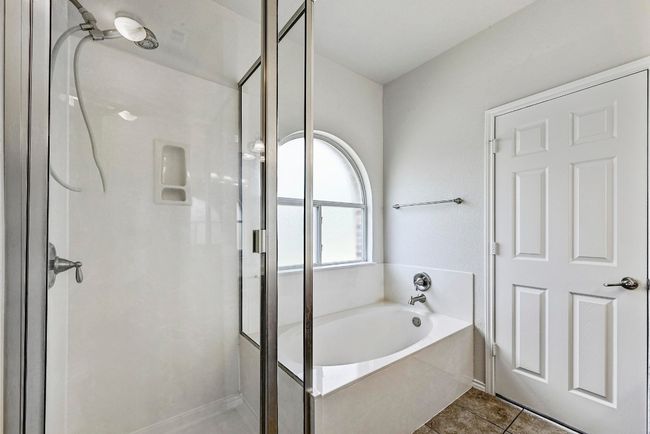 Bathroom with a shower stall, a bath, and tile patterned floors | Image 20