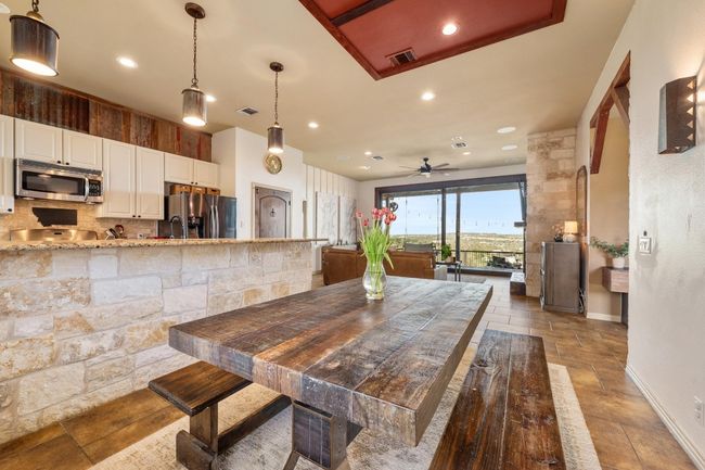 Dining space featuring recessed lighting, stone tile floors, ceiling fan, and visible vents | Image 14