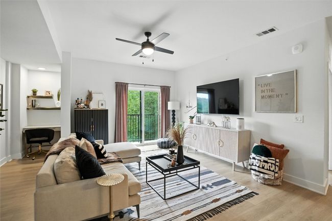 Living area featuring ceiling fan and wood finished floors | Image 20