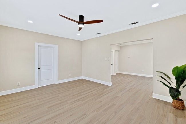 Spare room featuring light wood-style flooring, visible vents, baseboards, recessed lighting, and a ceiling fan | Image 5
