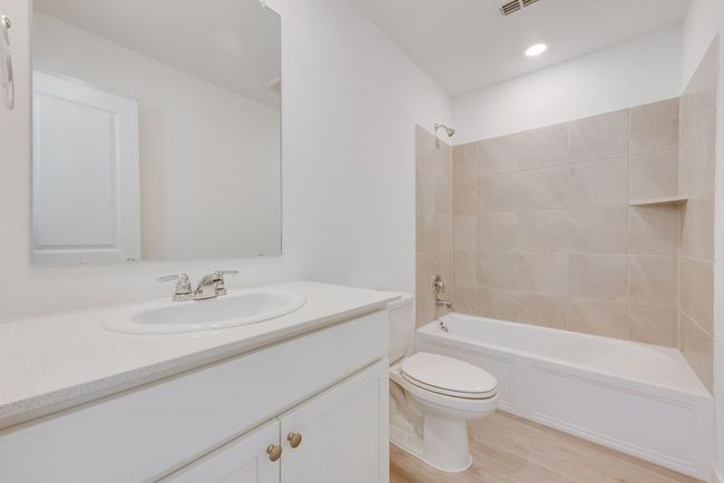 Full bathroom with vanity, shower / washtub combination, and wood finished floors | Image 7