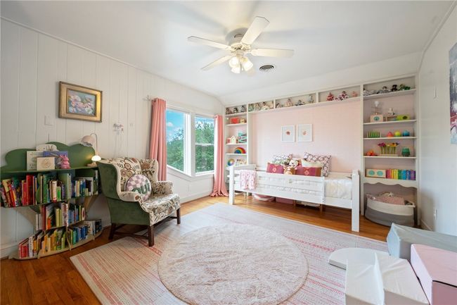 Bedroom with wood finished floors and a ceiling fan | Image 29