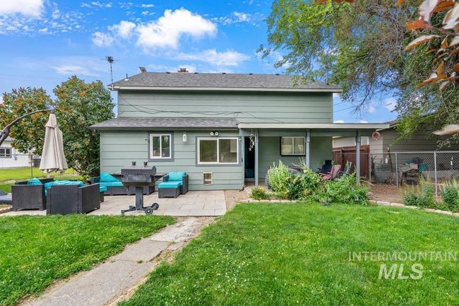 Back of house with an outdoor living space, a patio, and a shingled roof | Image 4