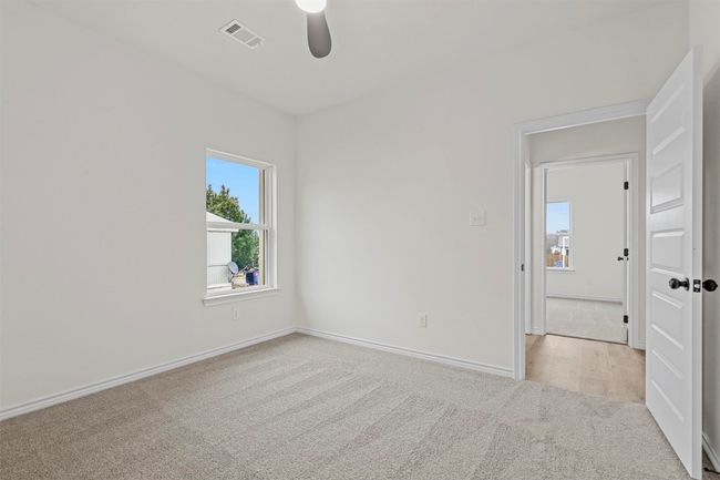 Empty room featuring ceiling fan and light colored carpet | Image 35