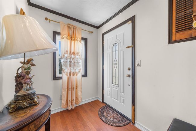 Entrance foyer with hardwood / wood-style flooring, ornamental molding, and baseboards | Image 5