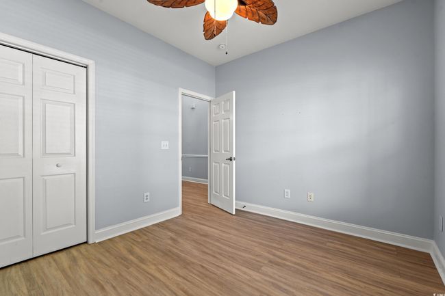 Unfurnished bedroom with a closet, ceiling fan, baseboards, and wood finished floors | Image 26