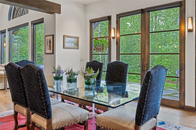 Dining area with huge windows to the backyard. | Image 26