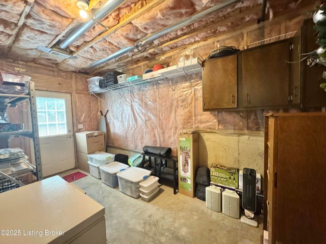 Unfinished area in basement with outside door | Image 40