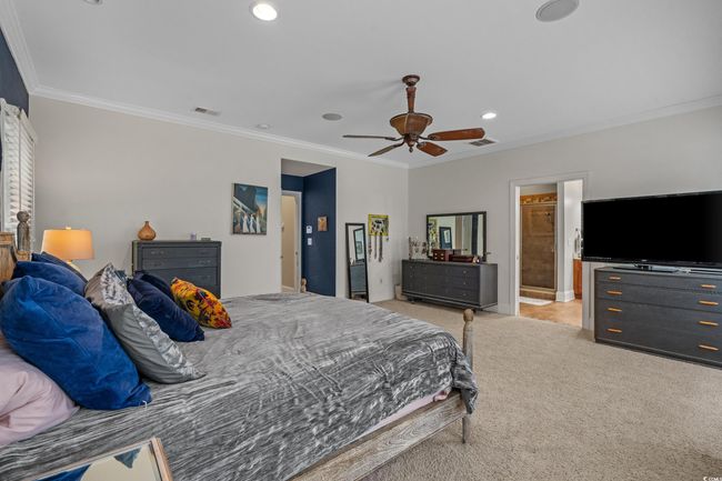 Carpeted bedroom featuring crown molding, recessed lighting, ceiling fan, and ensuite bath | Image 26