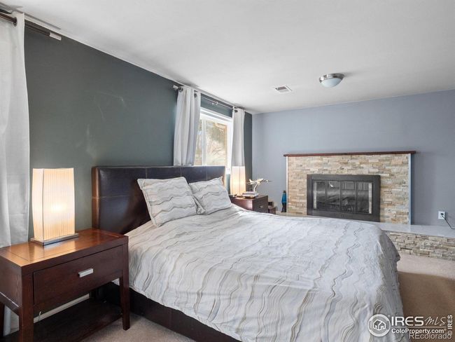 Lower level secondary primary bedroom or a family room with fireplace | Image 15