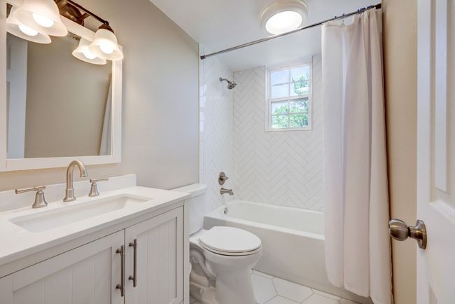 Full bath with tile patterned floors, shower / tub combo, vanity, and toilet | Image 8