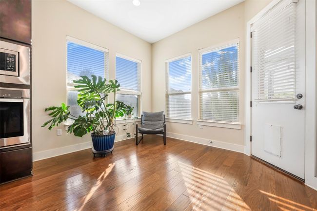 Living area featuring plenty of natural light and wood finished floors | Image 22
