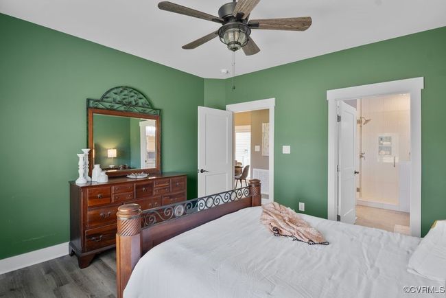 Bedroom featuring wood finished floors, ceiling fan, baseboards, and ensuite bath | Image 15