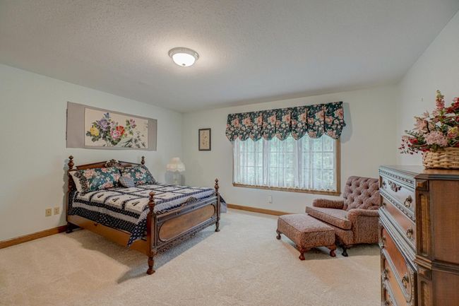 This junior suite features a private bath, providing luxurious comfort for guests or family | Image 27