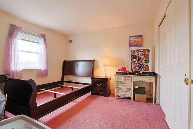 Bedroom with a closet, visible vents, baseboards, and carpet | Image 13
