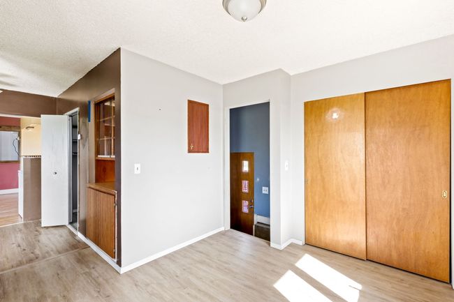 Unfurnished bedroom with light wood-style floors, baseboards, and a closet | Image 11