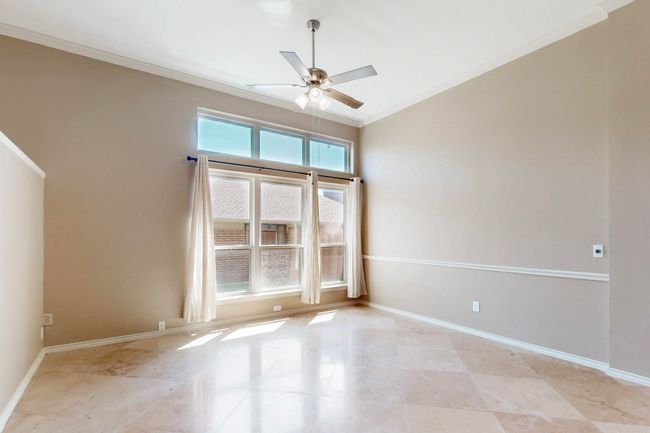 Empty room featuring baseboards, ornamental molding, and ceiling fan | Image 4