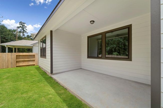 The covered patio is generously sized, providing ample space for various outdoor activities. | Image 21