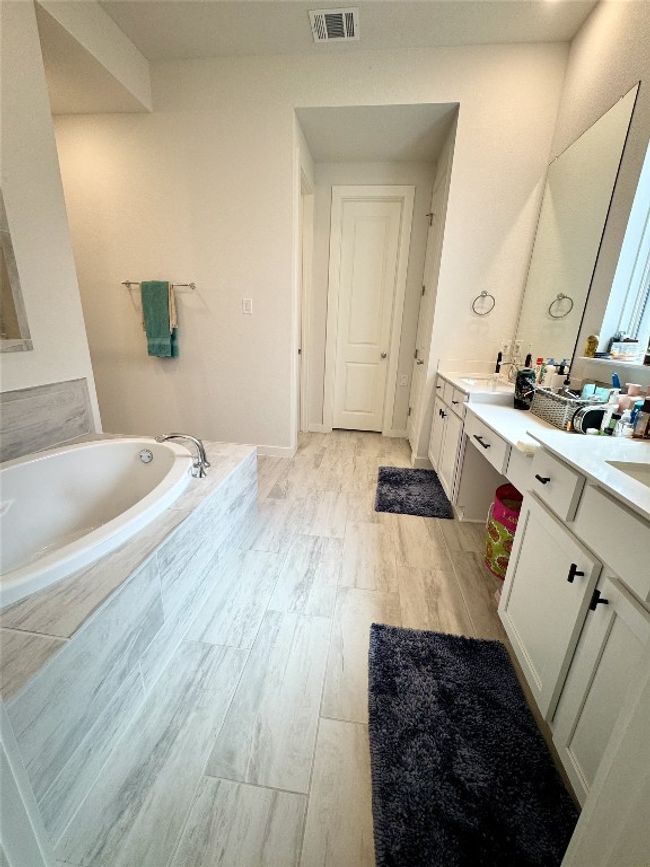 Full bath with double vanity, a bath, and wood finished floors | Image 18