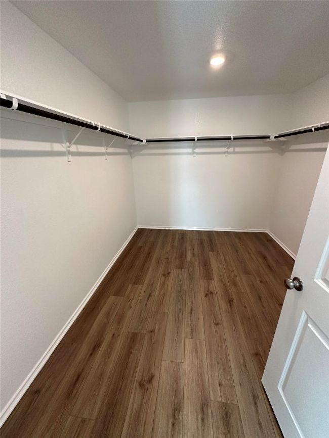 Walk in closet featuring wood finished floors | Image 14