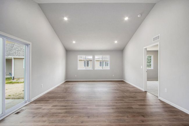 The open concept floorplan has full sight lines into the great room. There is an abundance of natural lighting from windows and is further enhanced by the vaulted ceilings and recessed lighting. | Image 9