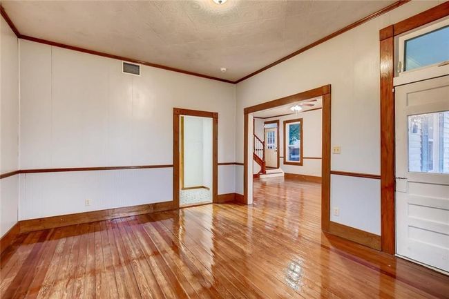 Unfurnished room with hardwood / wood-style flooring, crown molding, and baseboards | Image 9