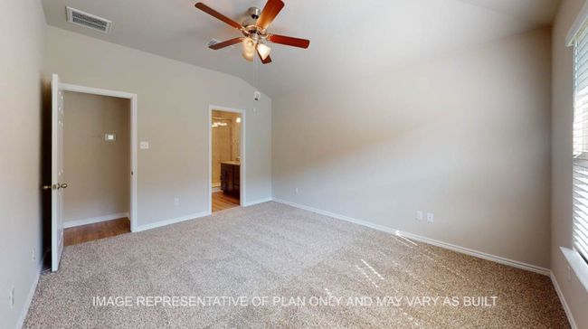 Unfurnished bedroom with carpet, lofted ceiling, baseboards, multiple windows, and ensuite bathroom | Image 16