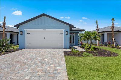 Single story home with a garage and a front lawn | Image 1