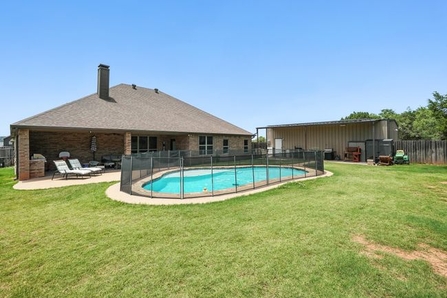 View of pool with a patio | Image 32