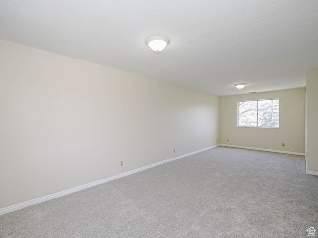 Carpeted empty room featuring baseboards | Image 40