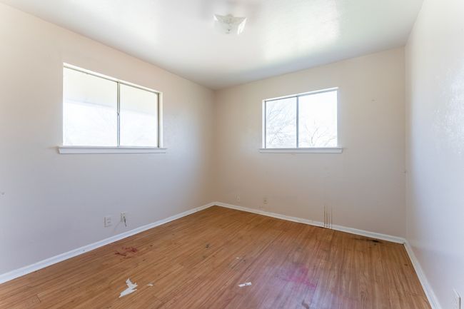 Empty room featuring baseboards and wood finished floors | Image 8