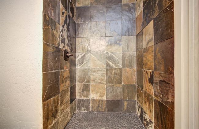 Beautiful slate tile in primary bath shower. | Image 10