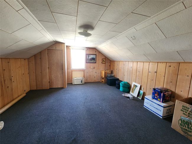 Bonus room featuring carpet flooring, wood walls, and vaulted ceiling | Image 33