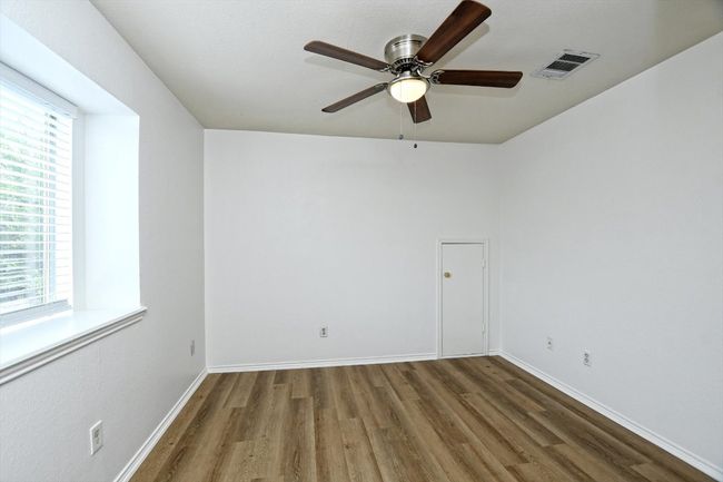 Empty room with wood finished floors and ceiling fan | Image 21