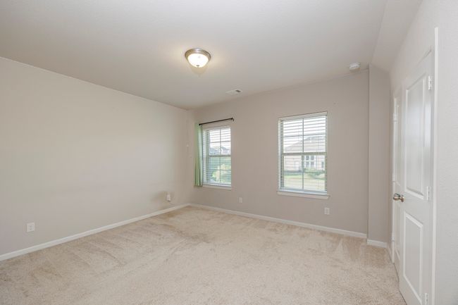 Unfurnished room featuring light carpet and a smoke detector | Image 26