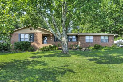 Front of home. Home sits on top of small hill. Parking on driveway, in garage and on the road in front of house. | Image 2