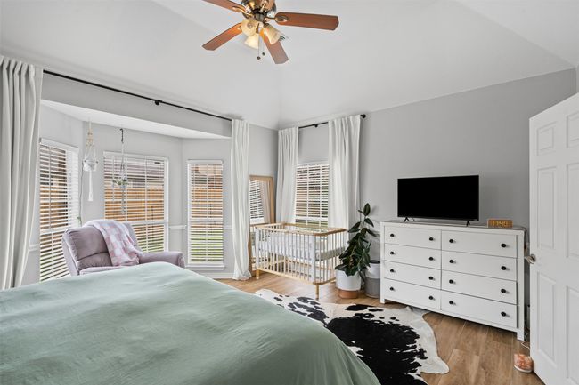 Bedroom with vaulted ceiling, laminate floors, and a ceiling fan | Image 21