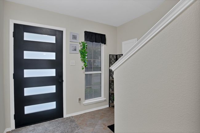 Entrance foyer with light tile patterned floors and baseboards | Image 4