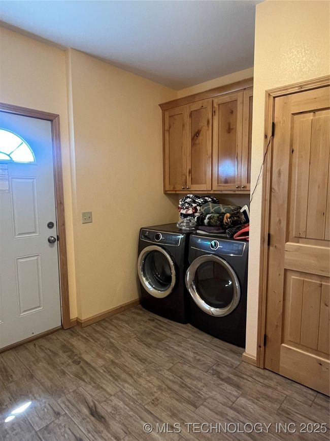 Laundry room with storage area | Image 26