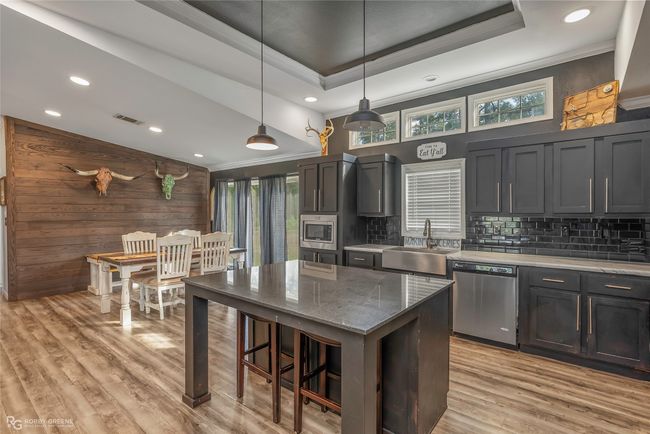 Kitchen featuring plenty of natural light, a sink, appliances with stainless steel finishes, and visible vents | Image 16