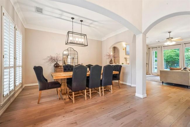 Dining area features large windows. | Image 21