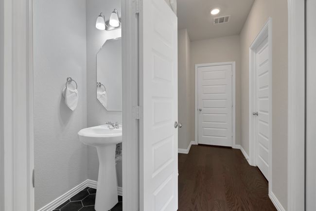 Bathroom featuring baseboards, visible vents, and wood finished floors | Image 25
