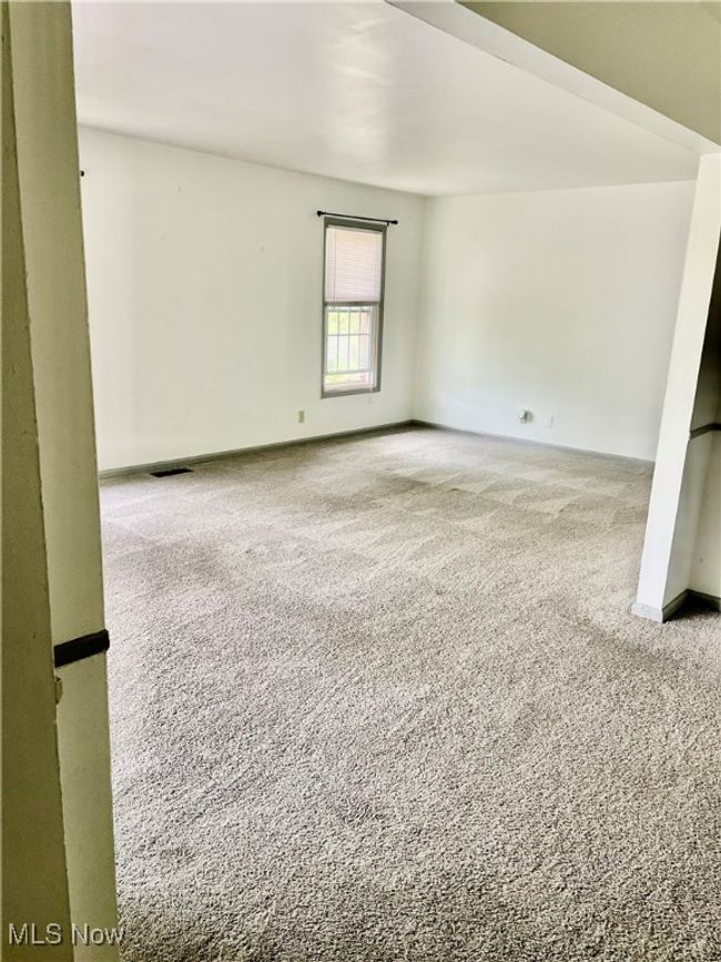 Living room with carpeted | Image 7