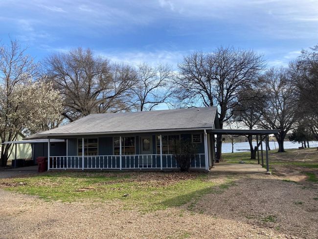 View of front facade featuring a porch, an attached carport, and a water view | Image 26