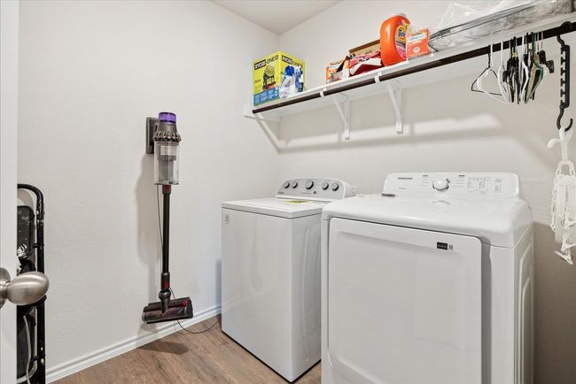 Washroom with separate washer and dryer and light wood-style flooring | Image 10