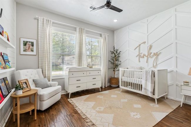 Secondary downstairs bedroom features a board and batten wall and a shiplap wall. | Image 25